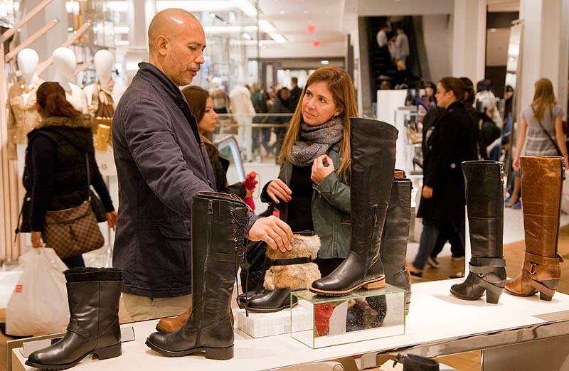 Customers shop for Rudsak shoes at Macy's shoe department in New York. Shoes are a top seller this holiday season.