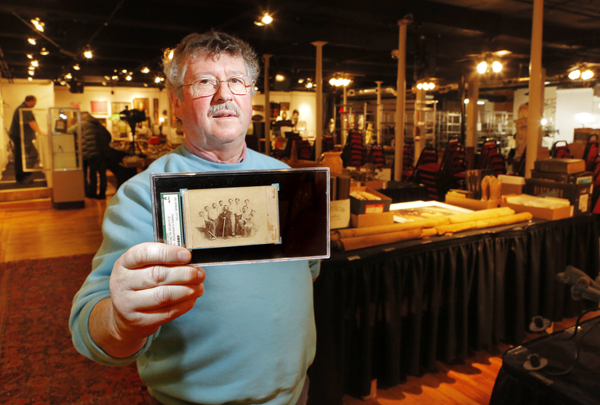 Floyd Hartford, owner of the Saco River Auction Co., holds an 1865 card of the Brooklyn Atlantics baseball team. Only two of the cards are known to exist and the other is at the Library of Congress.