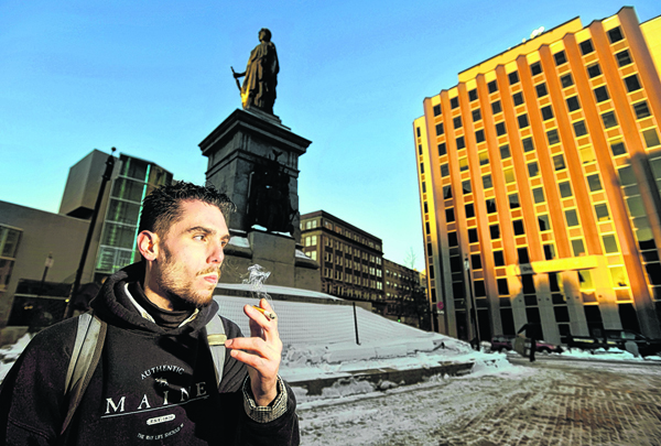 Jason Lemay, 26, of Portland, smokes a cigarette in Monument Square late Monday afternoon. Lemay says he is opposed to a proposed smoking ban in Monument Square and many other public spaces.