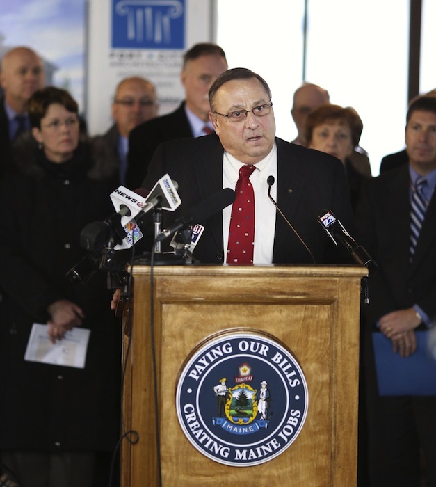 Speaking from a podium with a slogan of "Paying Our Bills, Creating Maine Jobs," Gov. Paul LePage held a press conference at the University of New England's College of Dental Medicine Patient Care Center Building, Tuesday, January 15, 2013, to announce his plan to pay hospitals back the $484 million they are owed by using future liquor-sale revenues as security against a bond that would pay the state's share of the hospital debt.