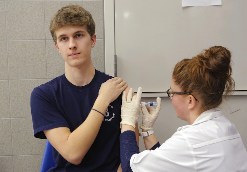 Kristin Harris, a pharmacist at Rite Aid on Forest Avenue in Portland, administers a flu shot to Justin Ehringhaus, a freshman at Bowdoin College, on Thursday, January 17, 2013.