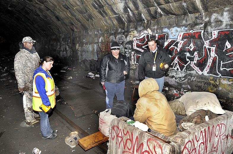 John Patriquin/Staff Photographer: Maine HUD field director Bill Burney, Angela Havlin, Alicia Martinez and Josh O'Brien all with the Oxford Street Shelter interview a homeless man in the tunnel under the Casco Bay Bridge as the city of Portland conducted its annual homeless point in time survey, Wednesday January 30,2013.