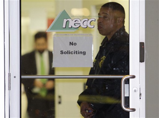 In this Oct. 16, 2012 file photo, a Food and Drug Administration Agent stands at the doorway of New England Compounding Center in Framingham, Mass., Tuesday, Oct. 16, 2012, as investigators work inside. The company's steroid medication was been linked to a deadly meningitis outbreak in one of Massachusetts's top stories in 2012.