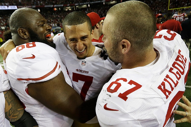 San Francisco quarterback Colin Kaepernick, center, celebrates with linemen Leonard Davis, left, and Daniel Kilgore after leading the 49ers to a 28-24 win over the Atlanta Falcons in the NFC championship game. The 49ers are headed to the Super Bowl for the first time in 18 years.