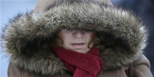 A Commuter bundles up against extreme cold conditions Tuesday, Jan. 22, 2013, in Chicago.Maine Gov. Paul LePage has declared a limited emergency to allow heating oil truck drivers to work extra hours to ensure timely deliveries during a period of extreme cold. (AP Photo/M. Spencer Green)