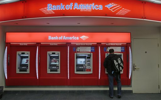 In this Dec. 13, 2012 photo, a customer stops at a Bank of America ATM office in Boston. Bank of America Corp. says it will spend more than $10 billion to settle mortgage claims resulting from the housing meltdown. Under the deal announced Monday, Jan. 7, 2013, the bank will pay $3.6 billion to Fannie Mae and buy back $6.75 billion in loans that the North Carolina-based bank and its Countrywide banking unit sold to the government agency from Jan. 1, 2000 through Dec. 31, 2008. That includes about 30,000 loans. (AP Photo/Charles Krupa)