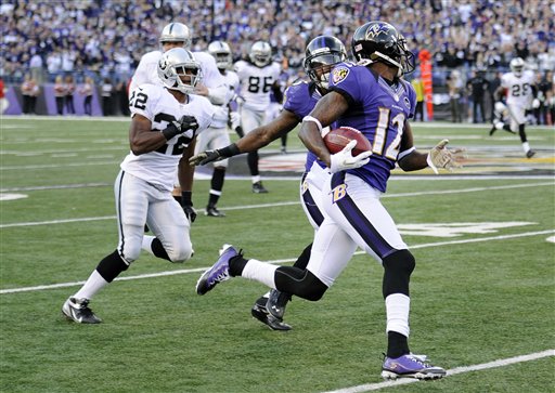 In this Nov. 11, 2012,photo, Baltimore Ravens wide receiver Jacoby Jones (12) looks back as he returns a kickoff 105 yards for touchdown during a game against the Oakland Raiders in Baltimore.