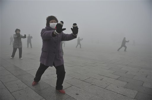 Retirees do Taichi during their morning exercise on a hazy day in Fuyang city, in central China's Anhui Province in this May 2014 photo. The Associated Press