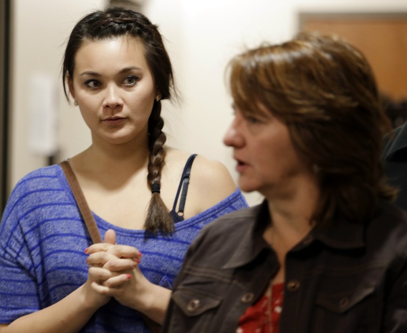 Chantel Blunk, left, is escorted by a victims assistant as she arrives for the third day of a preliminary hearing for Aurora theater shooting suspect James Holmes at the courthouse in Centennial, Colo., on Wednesday, Jan. 9, 2013. Chantel's husband Jon was killed in the shooting. (AP Photo/Ed Andrieski)