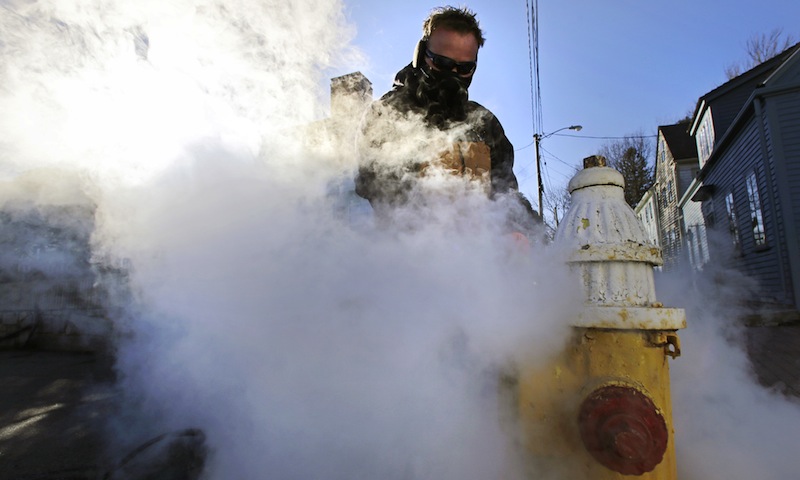 Jon Gilbert, of the Portsmouth, N.H. water department, steams a frozen hydrant in Portsmouth, N.H., Wednesday, Jan. 23, 2013. Temperatures in New Hampshire hovered close to single digits, with wind chill temperatures going below zero for most of the day. (AP Photo/Charles Krupa)