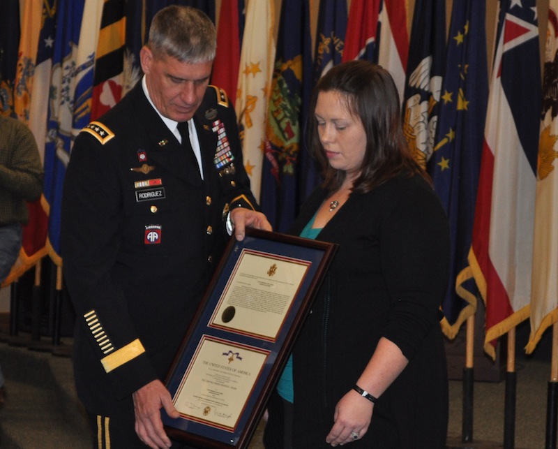 In this photo provided by the U.S. Army, Gen. David M. Rodriguez, commander of the Army’s U.S. Forces Command, presents a Distinguished Service Cross to Audrey Shaw, widow of Staff Sgt. Eric B. Shaw, during a ceremony held Wednesday, Jan. 16, 2013, at Fort Campbell, Ky. Shaw, who was killed in June 2010, is credited with saving the lives of 12 Afghan Army soldiers during a mission in Kunar Province, Afghanistan. (AP Photo/U.S.Army)