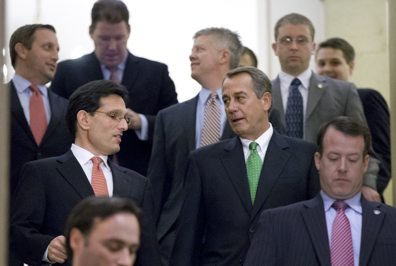 Speaker of the House John Boehner, R-Ohio, center right, and House Majority Leader Eric Cantor, R-Va., center left, head for a Republican conference meeting to discuss the "fiscal cliff" bill Monday in Washington.