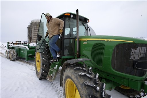 Shawn Georgetti climbs out of his John Deere tractor on his 167-acre family dairy farm in Avella, Pa., on Saturday. With royalties from a Range Resources gas well on his property, Georgetti has been able to buy newer farm equipment that's bigger, faster and more fuel-efficient.