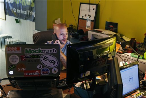 Matthew Marcus works at his desk in the basement of Kansas City Startup Village in Kansas City, Kan., on Friday. Marcus started the Village, which houses several startup companies and takes advantage of the high-speed Internet.