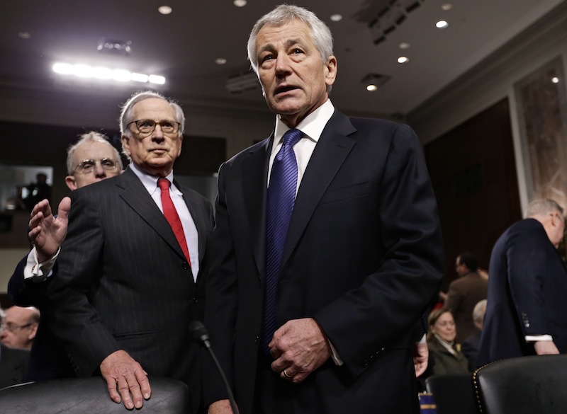 Republican Chuck Hagel, a former two-term senator and President Obama's choice to lead the Pentagon, arrives at the Senate Armed Services Committee for his confirmation hearing, on Capitol Hill in Washington, Thursday, Jan. 31, 2013. Former committee chairman, Democrat Sam Nunn, left, introduced Hagel. If confirmed, Hagel, a decorated Vietnam combat veteran, would be the first enlisted man to serve as defense secretary. (AP Photo/J. Scott Applewhite)