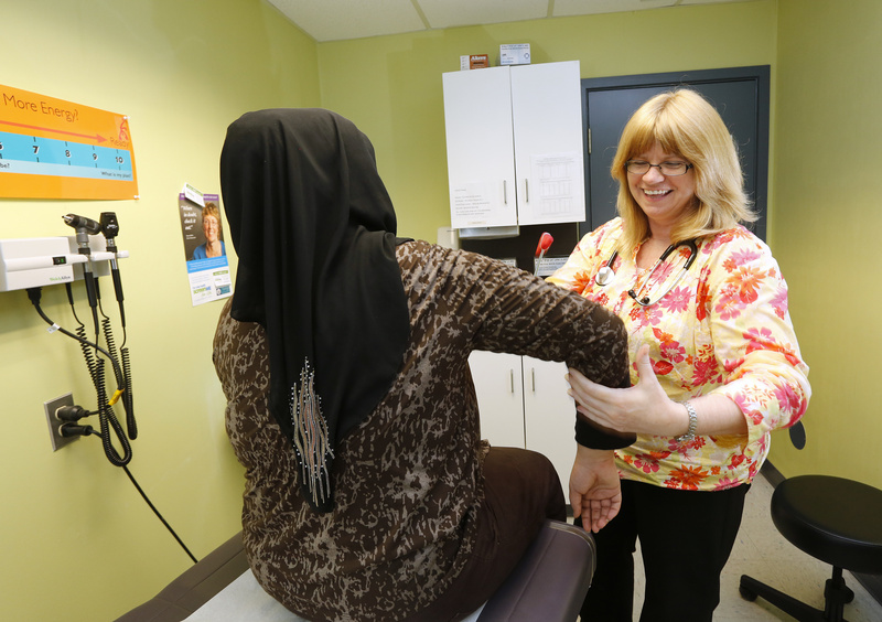 File Photo by Derek Davis: Patricia McGargill, a family nurse practitioner at Portland Community Health Center, tends to her patient Maha Dawood, 18, of Portland. Photographed on Thursday, June 28, 2012.