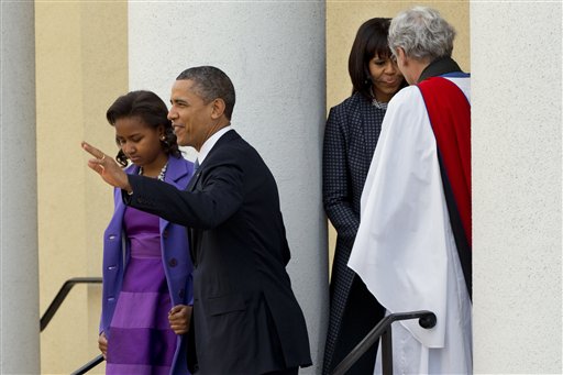 President Barack Obama, with daughter Sasha, waves as they leave St. John's Church in Washington on Monday, followed by first lady Michelle Obama, talking with Rev. Luis Leon, after attending a church service.