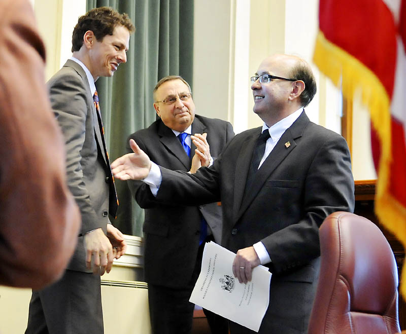 New Secretary of State Matt Dunlap, right, greets Maine Senate President Justin Alfond, left, after being sworn in to his post Monday in Augusta by Gov. Paul LePage.