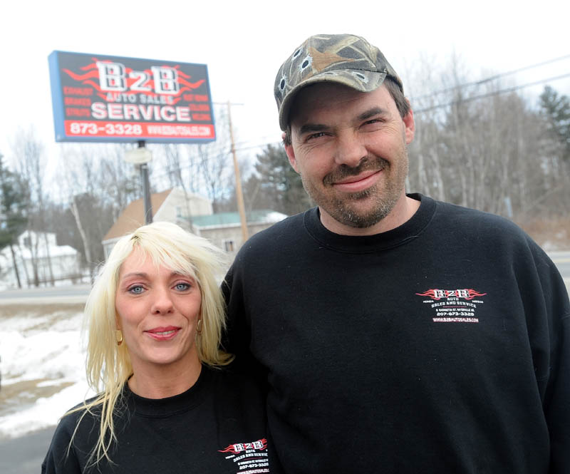 Shannon and Jason Hodgdon stand outsdie their B2B Car Service garage on Washington Street in Waterville on Thursday. The Hodgdons said they had to change the name of their business from Bumper to Bumper to B2B Auto Sales and Service, because of complaints of poor business practices by another garage in Bangor, named Bumper2Bumper.