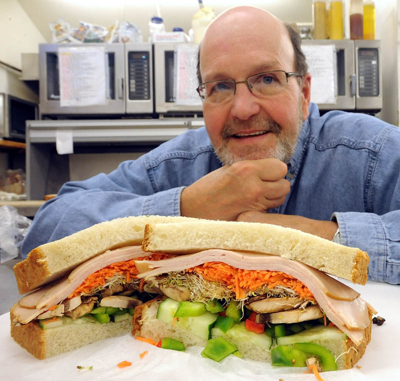 Gerry Michaud, co-owner of Big G's Deli on Benton Avenue in Winslow,poses next to his newly-named sandwich "41,470", named after the number of US deaths in the Vietnam conflict. The sandwich was formerly named the "Fonda."