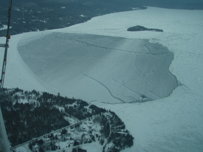 A photograph taken Friday from a Maine Warden Service aircradt of the area on Rangeley Lake, where three snowmobilers were lost on Sunday and presumed drowned. The section of lake has frozen over, further delaying search and recovery efforts, according to the warden service.