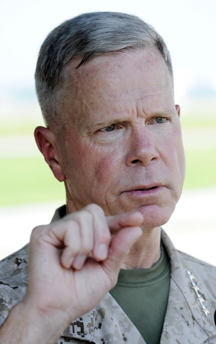 In this July 29, 2011 file photo, Marine Corps Commandant Gen. James Amos speaks with reporters at Patuxent River Naval Air Station, Md. The Marine Corps commandant said Thursday Jan. 31, 2013, the infantry side is skeptical about how women will perform in those units and some positions may end up being closed if not enough females fail to meet the rigorous standards. (AP Photo/Cliff Owen, File)