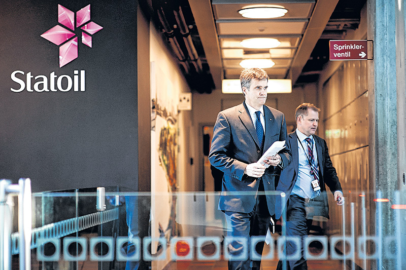 Statoil CEO Helge Lund, left, and director of foreign operations Lars Christian Bacher leave a meeting at the Statoil headquarters building in Stavanger, Norway, during Thursday’s hostage crisis.