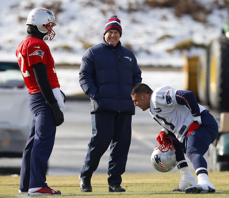 New England Patriots head coach Bill Belichick, center, smiles as he talks with quarterback Tom Brady (12) and tight end Aaron Hernandez (81) during practice at the NFL football team's facility Thursday, Jan. 17, 2013, in Foxborough, Mass. The Patriots will play the Baltimore Ravens in the AFC Championship game for the second year in a row at Foxborough this Sunday. (AP Photo/Stephan Savoia)