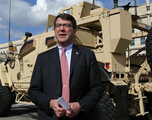 FILE - This Nov. 2, 2009, file photo shows Deputy Defense Secretary Ashton Carter standing in front of a MRAP all terrain vehicle (M-ATV) at the Pentagon in Washington. The Afghan war effort eventually would be harmed by across-the-board budget cuts, even as the Obama administration intends to shield the military's combat mission from the reductions, Carter said. "There will be second-order effects on the war," Carter said. (AP Photo/Manuel Balce Ceneta, File)