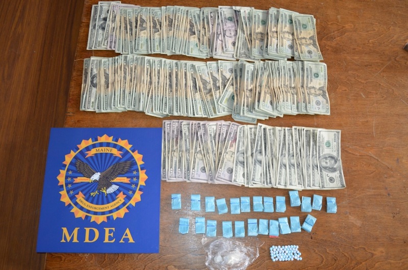 Agents with the Maine Drug Enforcement Agency searched a home and a motel room Monday morning and seized 157 bags of heroin, 20 grams of crack cocaine and $8,200 in cash as well oxycodone and amphetamine capsules, police said. In the provided police photo above, the seized contraband.