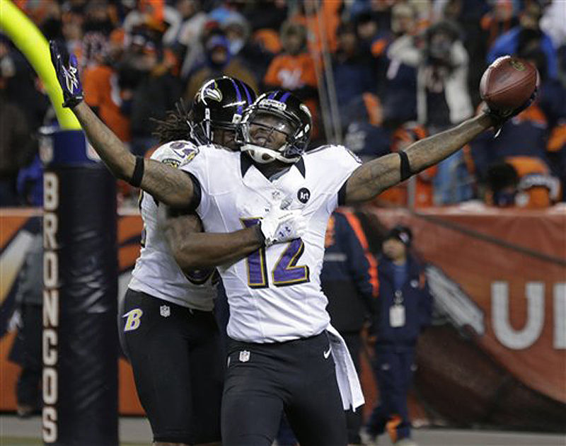 Baltimore Ravens wide receiver Jacoby Jones (12) celebrates with Ravens wide receiver Torrey Smith (82) after scoring a touchdown against the Denver Broncos to tie the score late in the fourth quarter of their AFC divisional playoff game Saturday in Denver. The Ravens won 38-35 in double overtime.