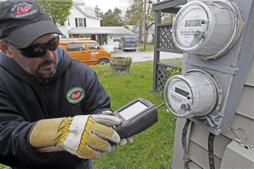 FILE- In this May 10, 2012 file photo, Mark Delbeck of Burlington Electric, checks the radio frequency of a newly-installed smart meter in Burlington, Vt. The Vermont Public Service Department has submitted its report on smart meters in Vermont to the Senate Committee on Finance and the House Committee on Commerce and Economic Development. It concluded that any potential exposure to the investigated smart meters will comply with the FCC exposure rules by a wide margin.(AP Photo/Toby Talbot)