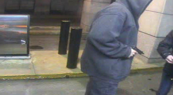 A surveillance image of the suspect, who is described as about 6 feet 2 inches tall, light-skinned and wearing jeans and a hooded sweatshirt.