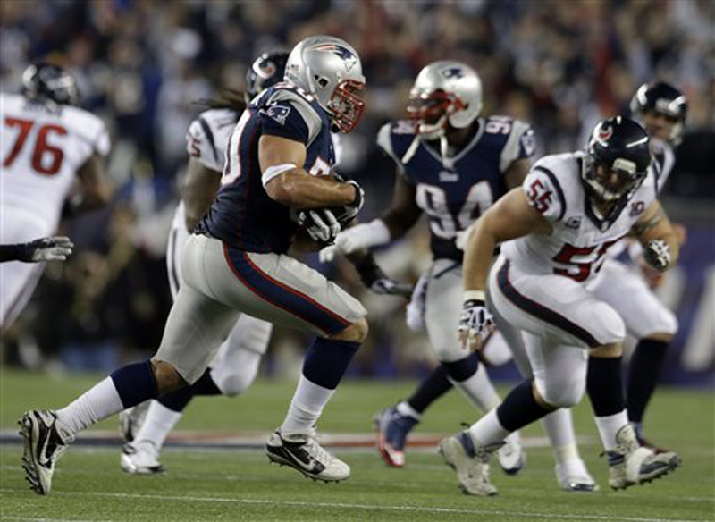 Patriots defensive end Rob Ninkovich (50) runs with the ball after intercepting a pass intended for Texans fullback James Casey during the second half Sunday.