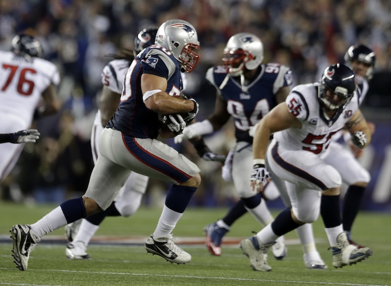 New England Patriots defensive end Rob Ninkovich (50) runs with the ball after intercepting a pass intended for Houston Texans fullback James Casey during the second half of an AFC divisional playoff NFL football game in Foxborough, Mass., Sunday, Jan. 13, 2013. (AP Photo/Elise Amendola)