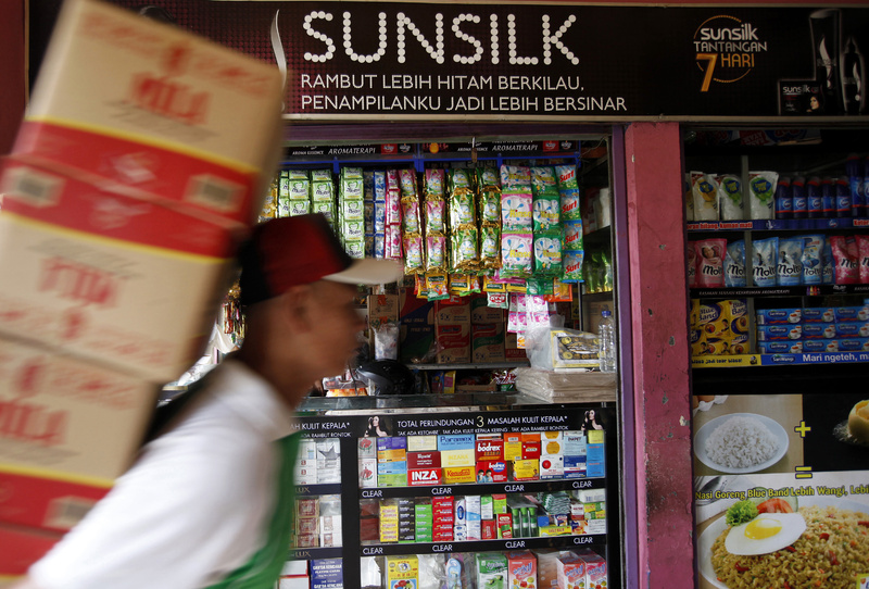 An advertisement for Unilever's Sunsilk line of hair care products is displayed above a store in Jakarta, Indonesia.