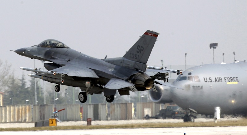 In this file photo a 31st Fighter Wing United State Air Force F-16 jet fighter lands at the Aviano NATO airbase, in Aviano, Italy, Friday, March 25, 2011. The headquarters of the 31st Fighter Wing issued a brief statement saying they lost contact with a F-16 fighter with one pilot aboard Monday, Jan. 28, 2013, during a training mission off the coast of Italy. Initial word was that the F-16 was not carrying weapons. There was no immediate word on the fate of the plane or the pilot. In background a C-17 plane is seen. (AP Photo/Luca Bruno)