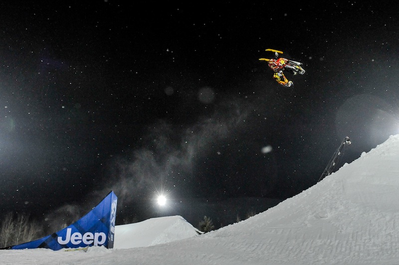 In this photo taken Jan. 24, 2013, Caleb Moore does a flip before he crashed during the ESPN Winter X Games snowmobile freestyle competition in Aspen, Colo. Moore died Thursday after suffering complications from injuries sustained during the snowmobile crash. He was 25.