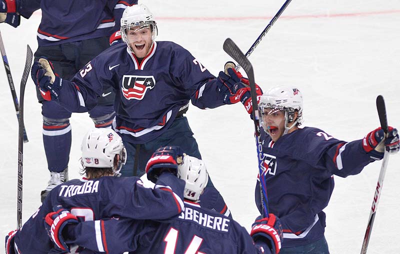 Rocco Grimaldi, top, celebrates his second goal against Sweden with teammates, from left, Jacob Trouba, Shayne Gostisbehere and Vince Trocheck during the second period Saturday in the gold-medal game at the IIHF World Junior Championships in Ufa, Russia. The U.S. won, 3-1. 2012;2013;athlete;athletes;athletic;athletics;Bronze;Canada;Cana