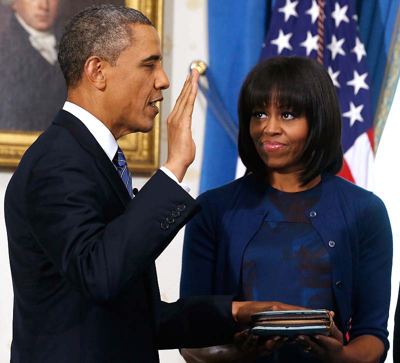 President Barack Obama is officially sworn in by Chief Justice John Roberts in the Blue Room of the White House during the 57th Presidential Inauguration in Washington on Sunday, as first lady Michelle Obama, holds the Robinson Family Bible.