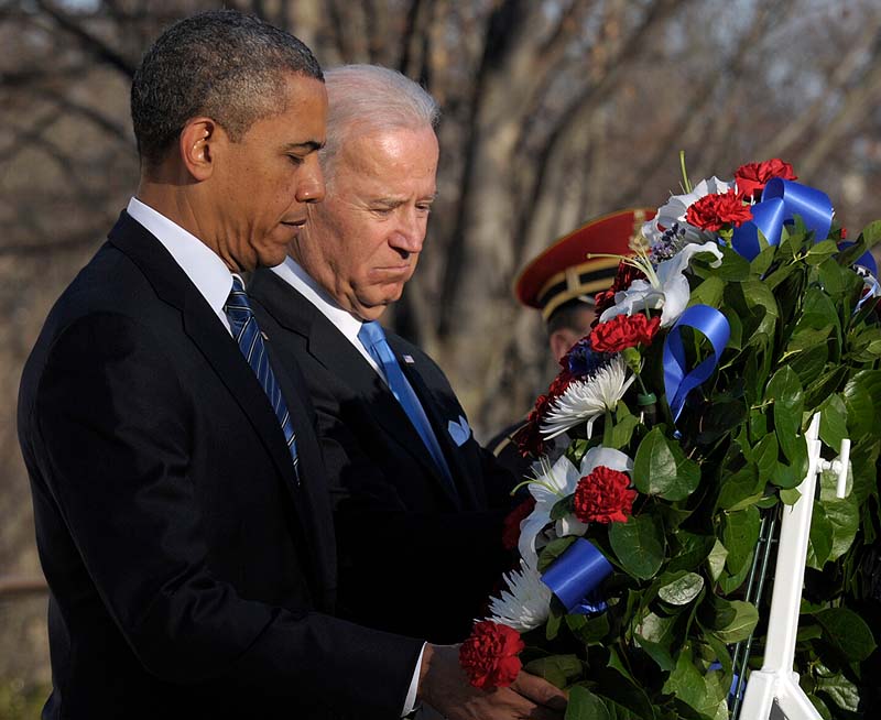 President Barack Obama and Vice President Joe Biden place a wreath at the Tomb of the Unknowns at Arlington National Cemetery in Arlington, Va., on Sunday.