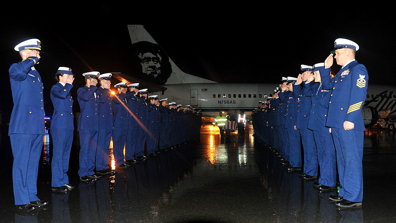 The crew of the Coast Guard Cutter Munro renders honors to their fallen shipmate Fireman Derek Russell at the Kodiak State Airport in Kodiak, Alaska, Thursday, Dec. 27, 2012. Russell, who suffered a fatal fall while hiking on Barometer Mountain Sunday, was recovered by Alaska State Troopers, Kodiak Island Search and Rescue and the Coast Guard Tuesday following several searches for him. U.S. Coast Guard photo by Petty Officer 1st Class Sara Francis.