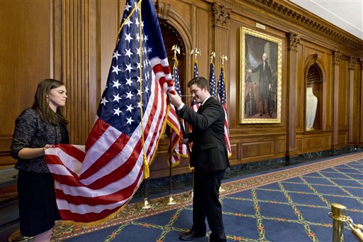 Anne Easby-Smith, left, and Trace Robbins, right, who work for House Speaker John Boehner, help to prepare the Rayburn Room on Capitol Hill in Washington,Wednesday, Jan. 2, 2013, where members of the House of Representatives will pose for pictures at an oath of office ceremony with Boehner. (AP Photo/J. Scott Applewhite)