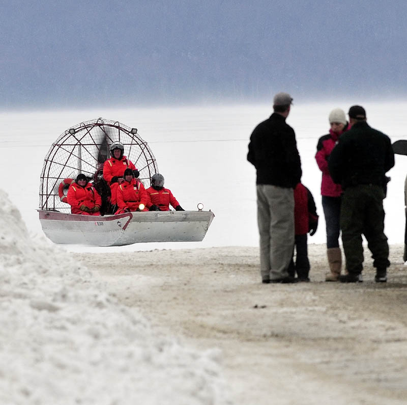 Maine Warden Service personnel return to shore in an airboat on Rangeley Lake on Monday after motoring over ice. Wardens said Dawn Newell's body was recovered Monday after the snowmobile she was riding broke through the ice Sunday night.