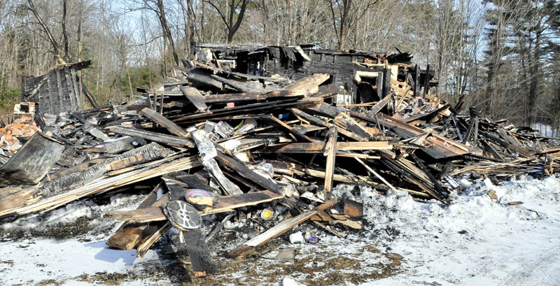 Remains of part of a huge barn that burned last Saturday at the home of Maine filmmaker Richard Searls on the River Road in Solon. Lost in the fire were tractors, farm equipment, tools and a lifetime of master film reels and original videotape.
