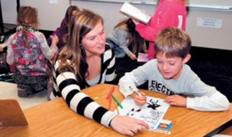 Cornville Regional Charter School teacher Danielle Beaman helps student Barret Walker last fall. The school opened in October with 60 students and plans to expand to 90 this fall.