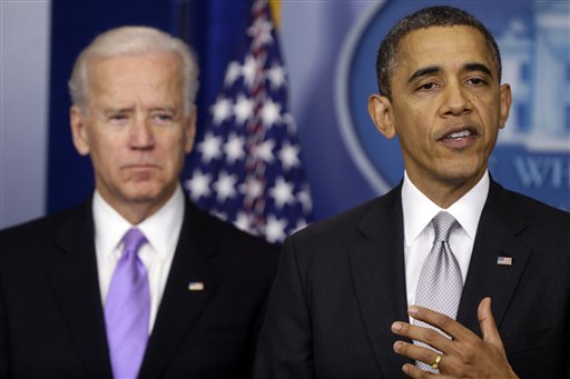 President Barack Obama stands with Vice President Joe Biden as he makes a statement Wednesday, Dec. 19, 2012. Acknowledging opposition in Congress, President Obama says he will present a plan within days, which may include stronger background checks and limits on high-capacity ammunition magazines. (AP Photo/Charles Dharapak)