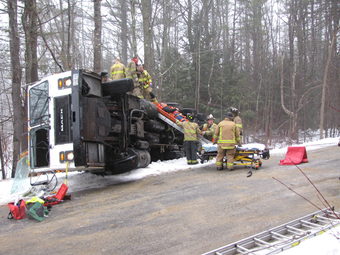 Emergency personnel work to remove a man from the scene of a truck rollover in Windham this morning. The man's identity and his condition were not available. Contributed photo by Elizabeth Nangle.