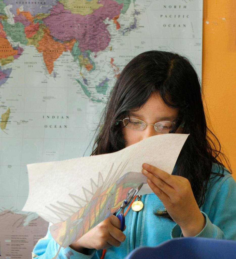 Carol Hong, a fourth grader at Reiche School, cuts out a drawing of a fish during an after school program at LearningWorks in Portland's West End in this May 6, 2009 file photo.