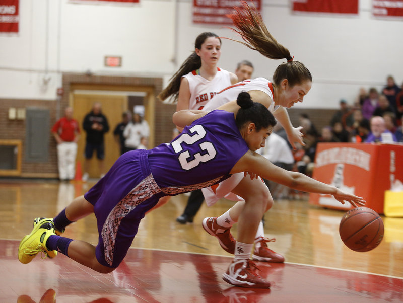 Keneisha DiRamio of Deering dives in an attempt to reach a loose ball ahead of Danica Gleason of South Portland during their games between undefeated SMAA teams Monday. Deering came away with a 45-37 victory on the road.